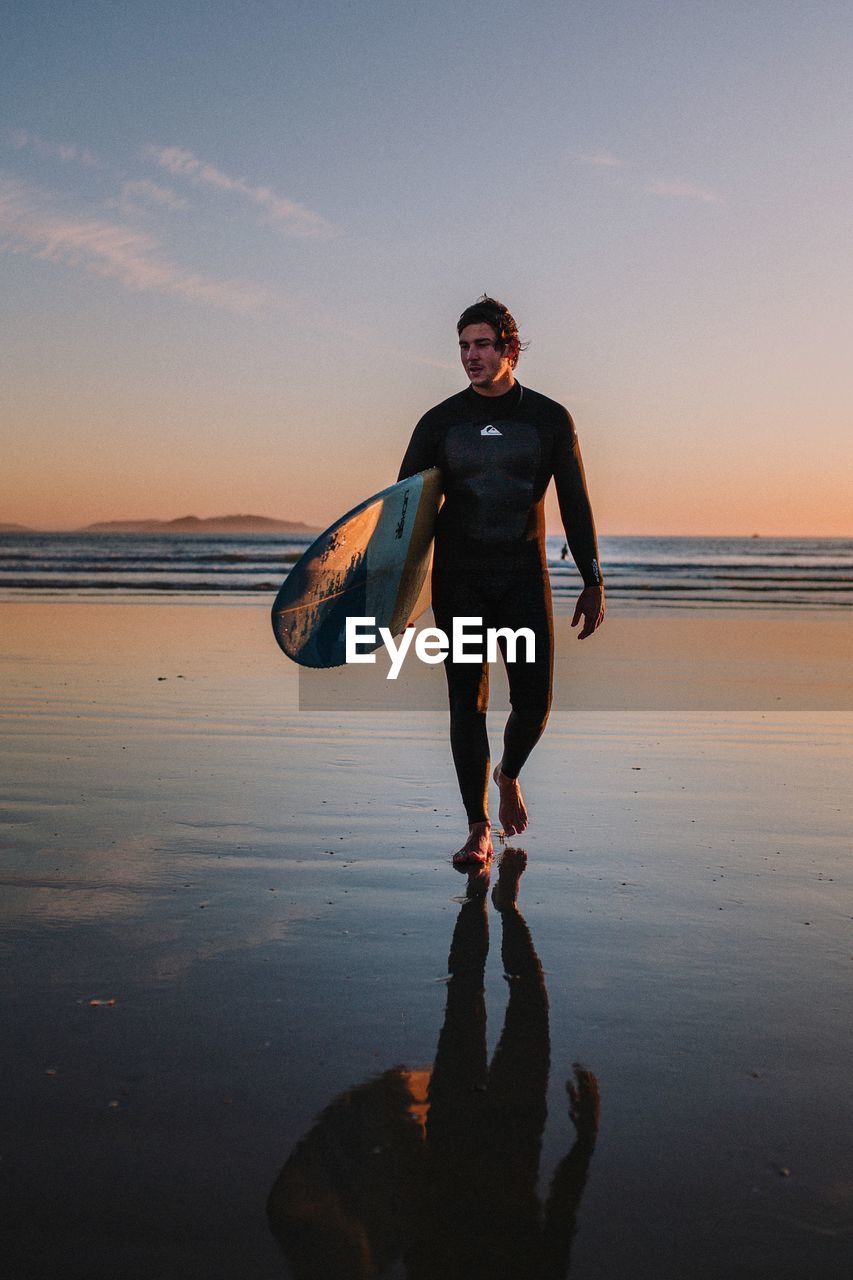 FULL LENGTH OF MAN STANDING ON BEACH