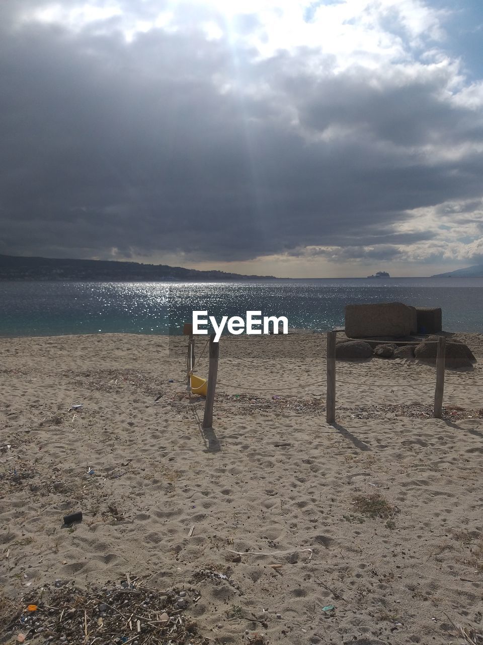 CHAIR ON BEACH AGAINST SKY