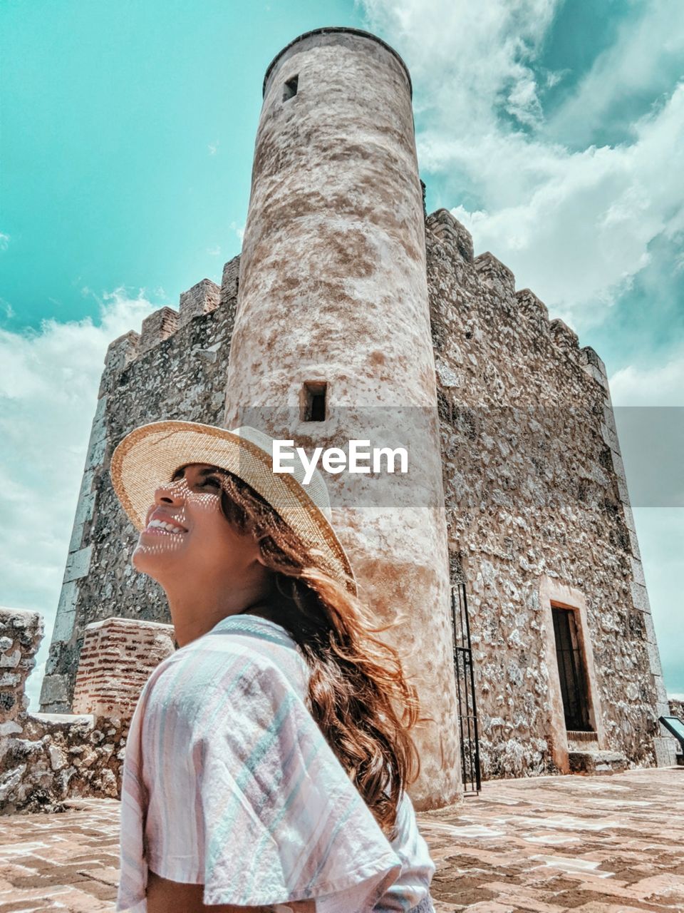 Woman standing against built structure