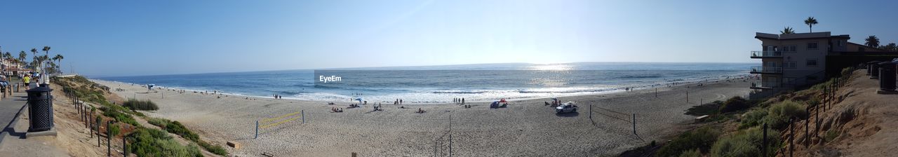 Panoramic view of beach against clear blue sky