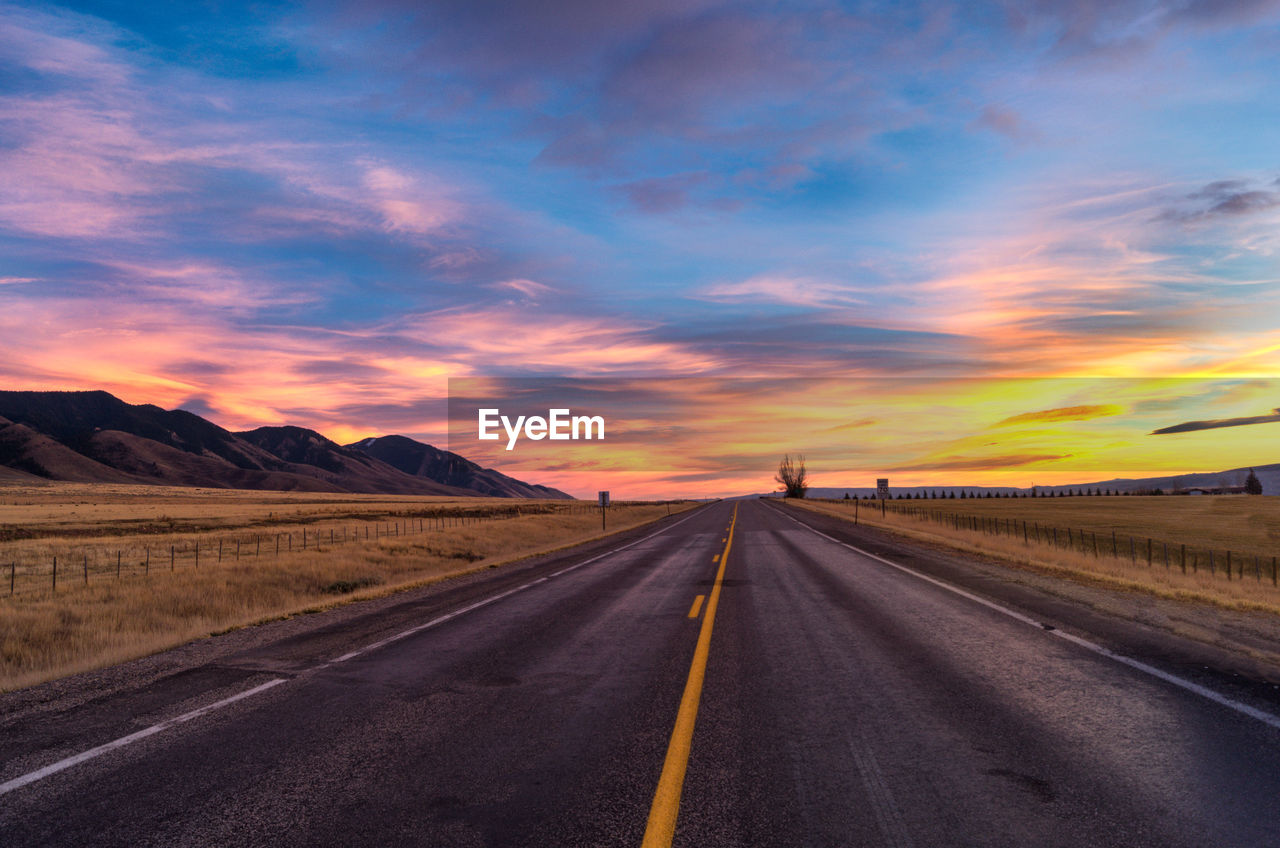 Road against dramatic sky during sunset