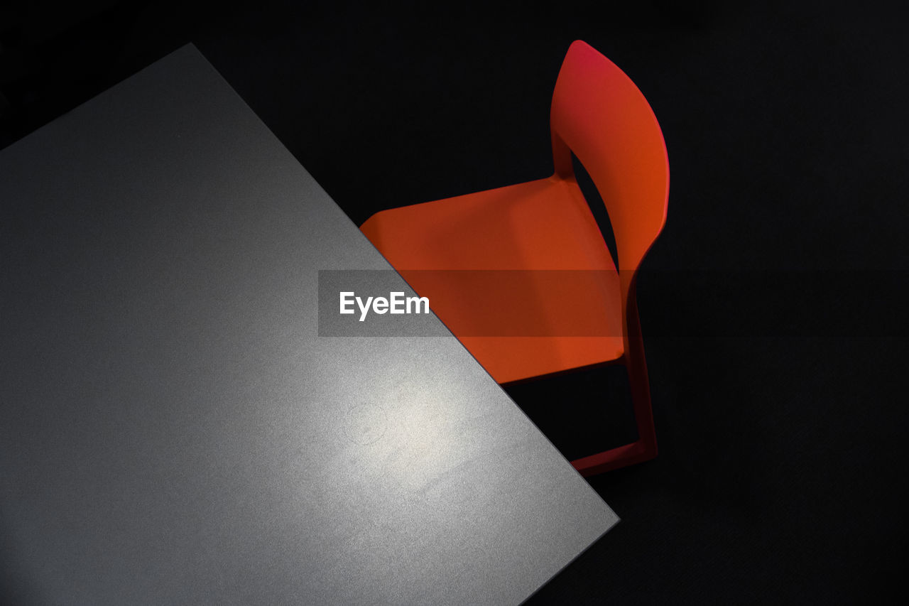 High angle view of table and chair against black background