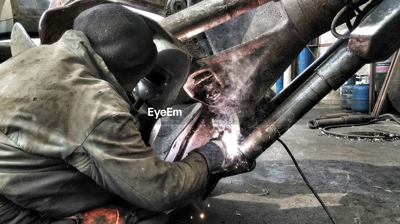 Rear view of welder working