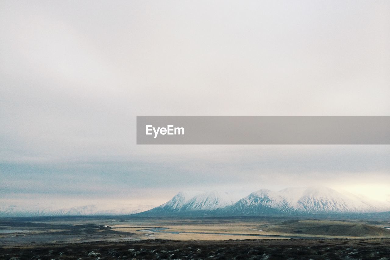 Empty field with mountains in background