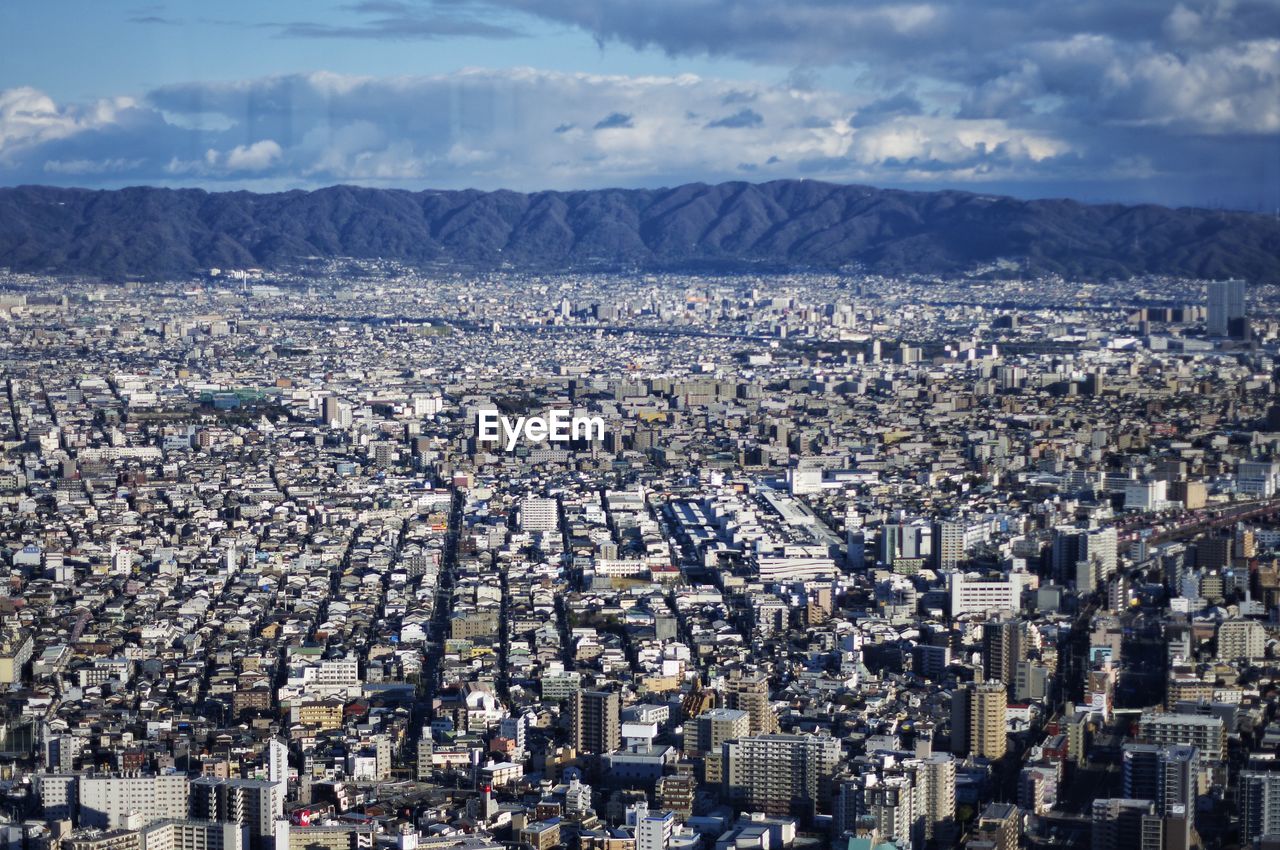 High angle view of city against cloudy sky