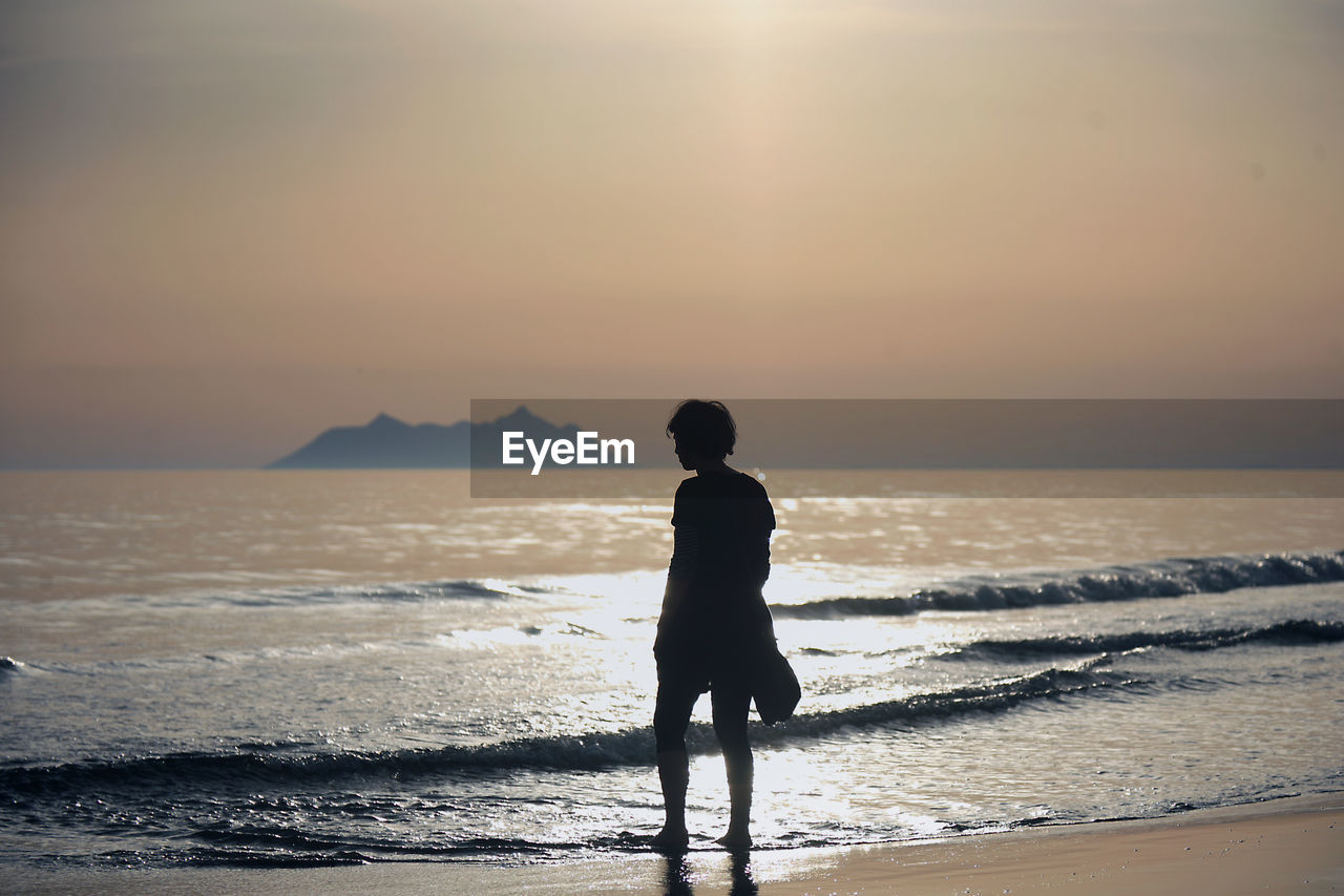 Woman standing on sea shore
