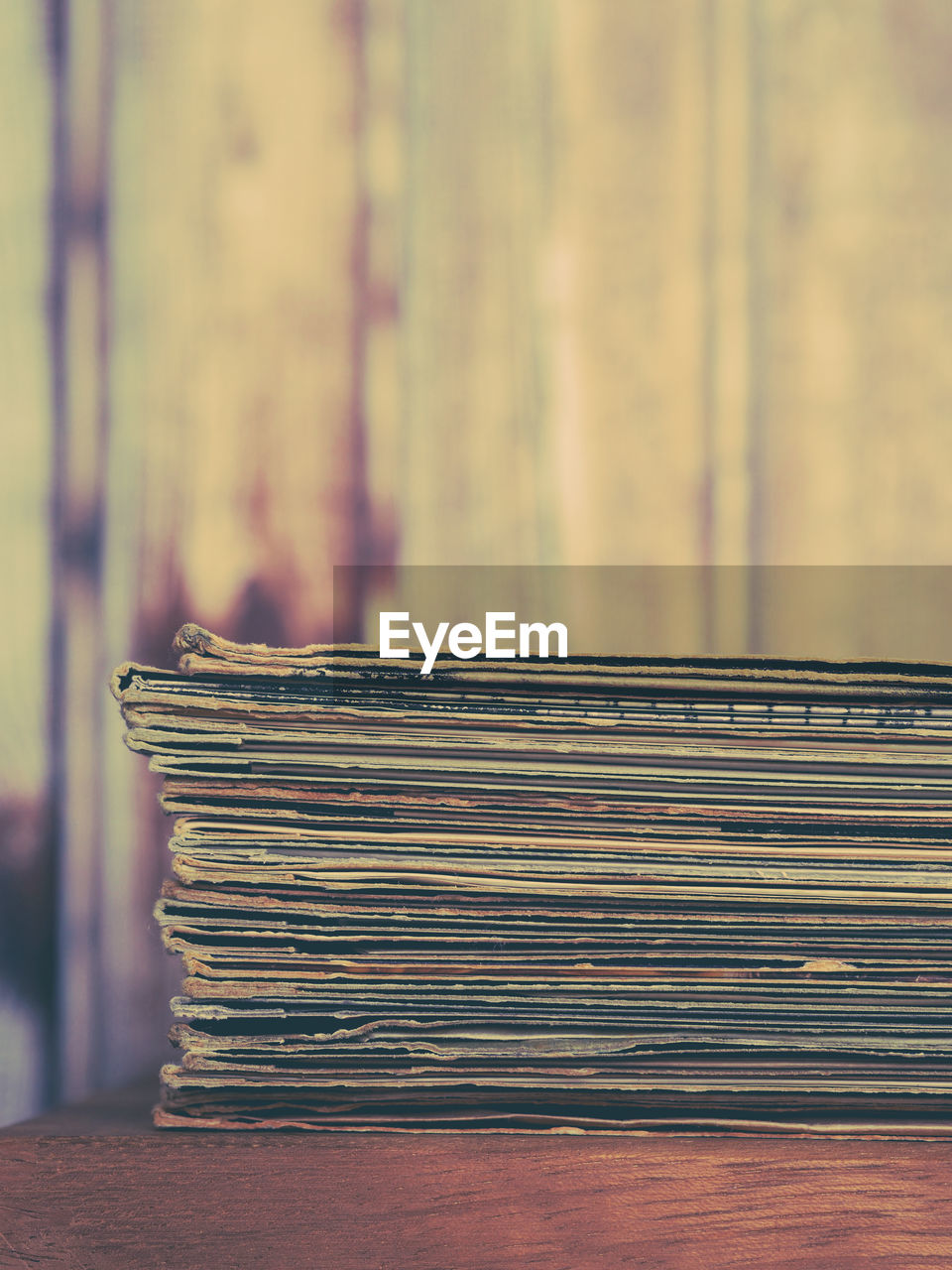 Lp vinyl records stacked close up with textured wood background copy space