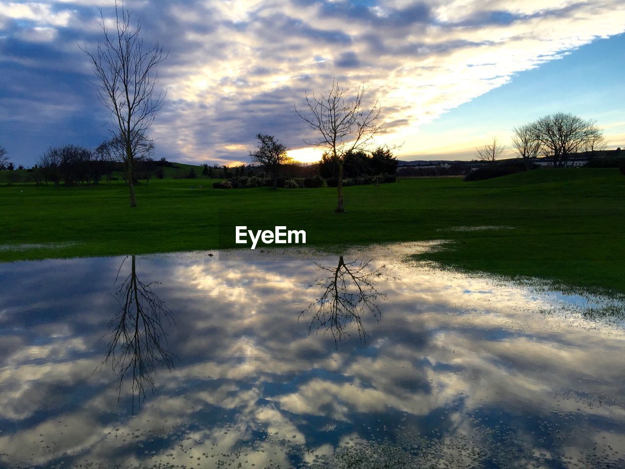 REFLECTION OF CLOUDS IN SKY DURING SUNSET