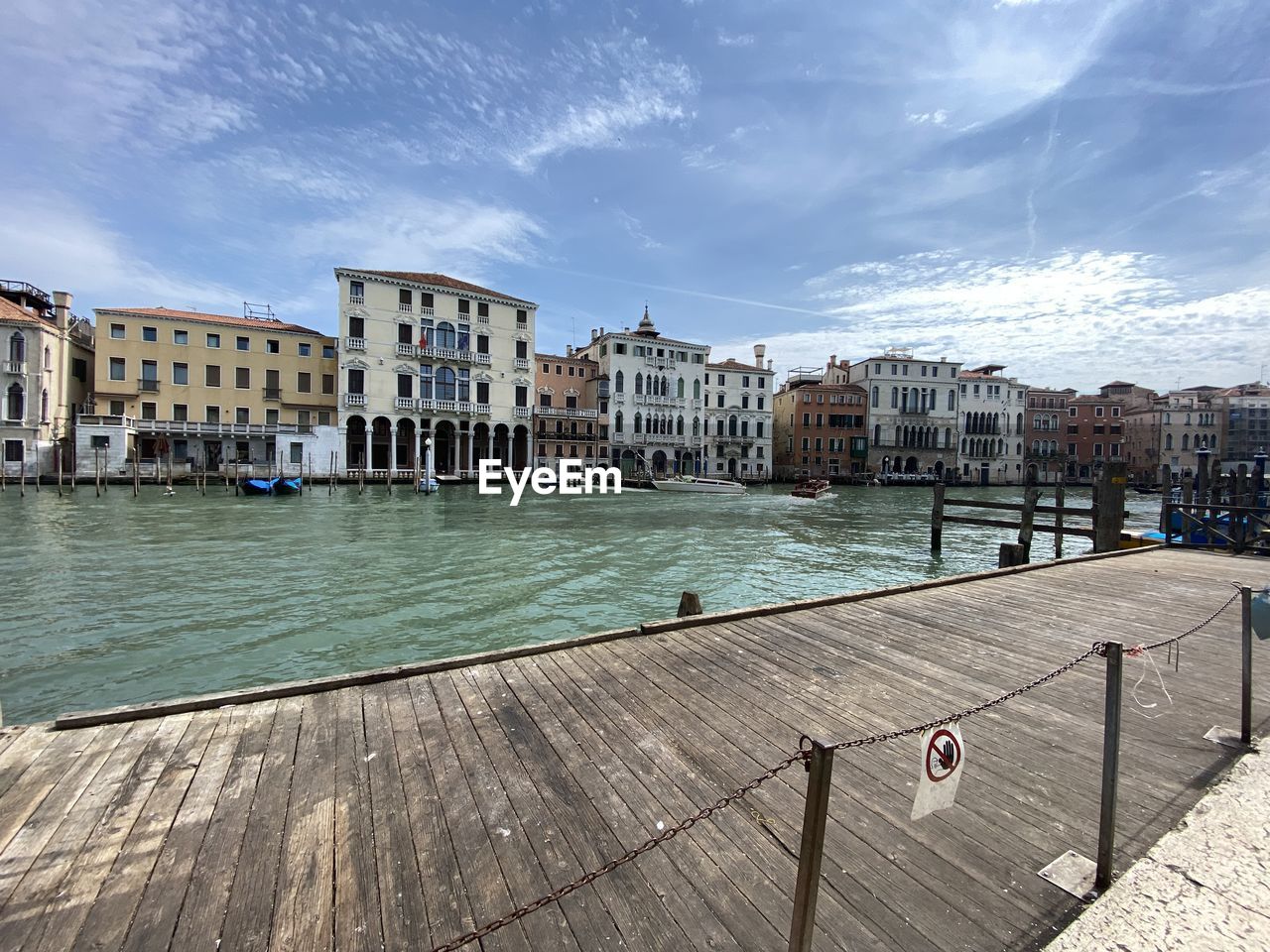 architecture, built structure, building exterior, water, city, sky, nature, travel destinations, building, travel, cloud, transportation, town, nautical vessel, sea, cityscape, tourism, dock, sunlight, mode of transportation, day, pier, boardwalk, walkway, outdoors, no people, residential district, wood, land, holiday, body of water, trip, vacation