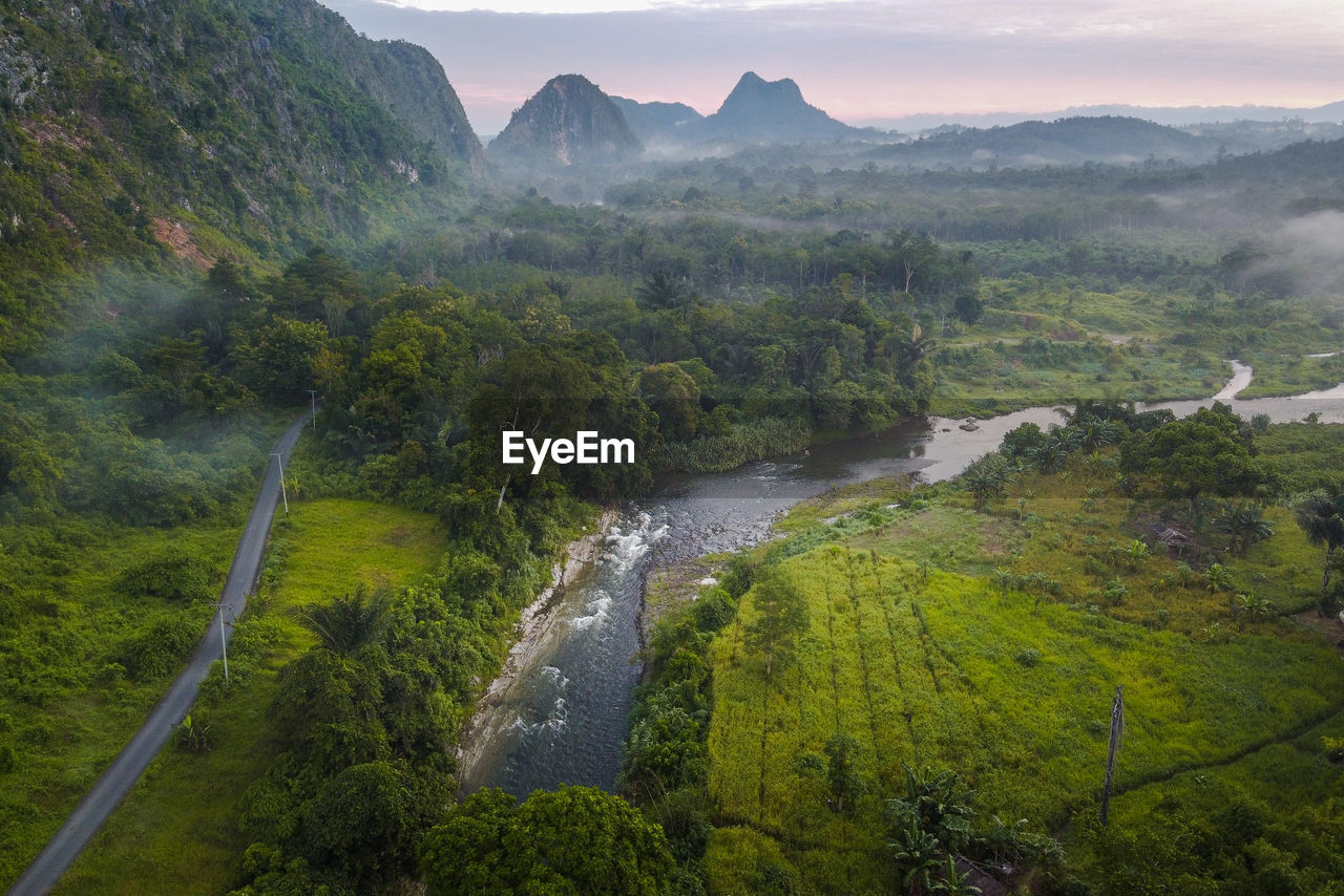 Scenic view of river amidst mountains against sky