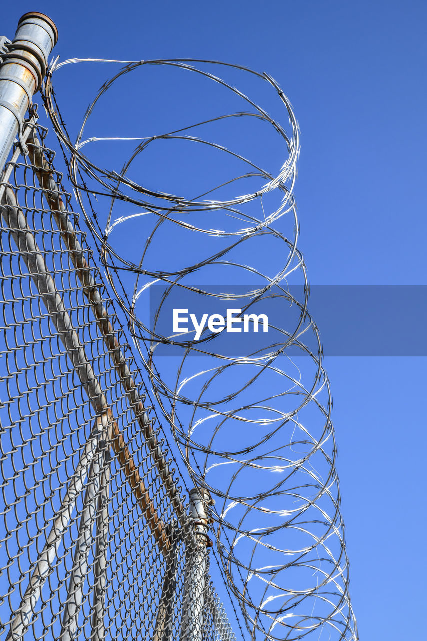 Razor wire on top of metal fence