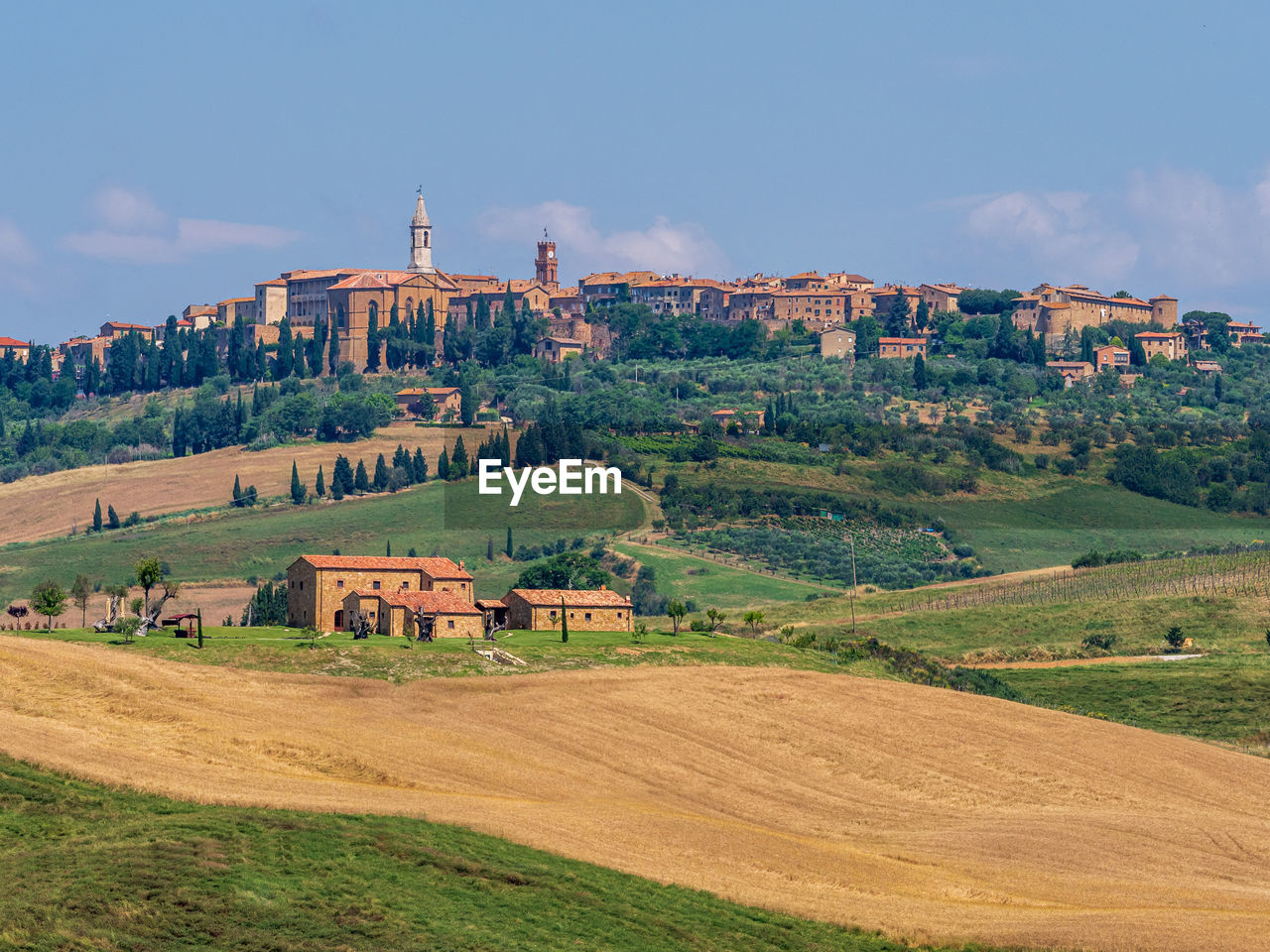 Farmhouse on a hill in the tuscany landscape.