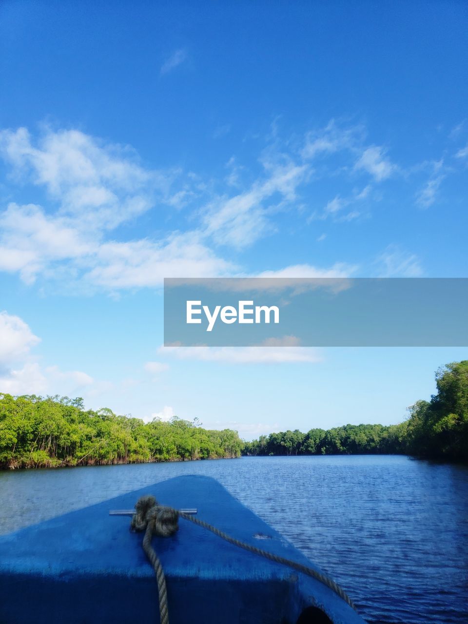 Scenic view of river against blue sky