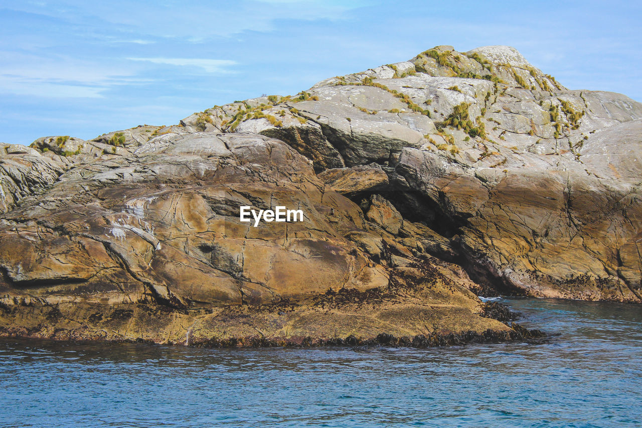 SCENIC VIEW OF ROCKS IN SEA AGAINST SKY