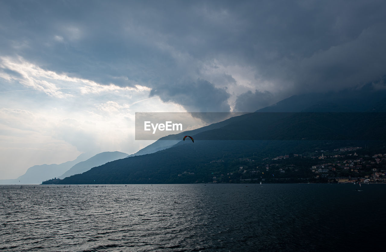 Scenic view of sea by city against sky