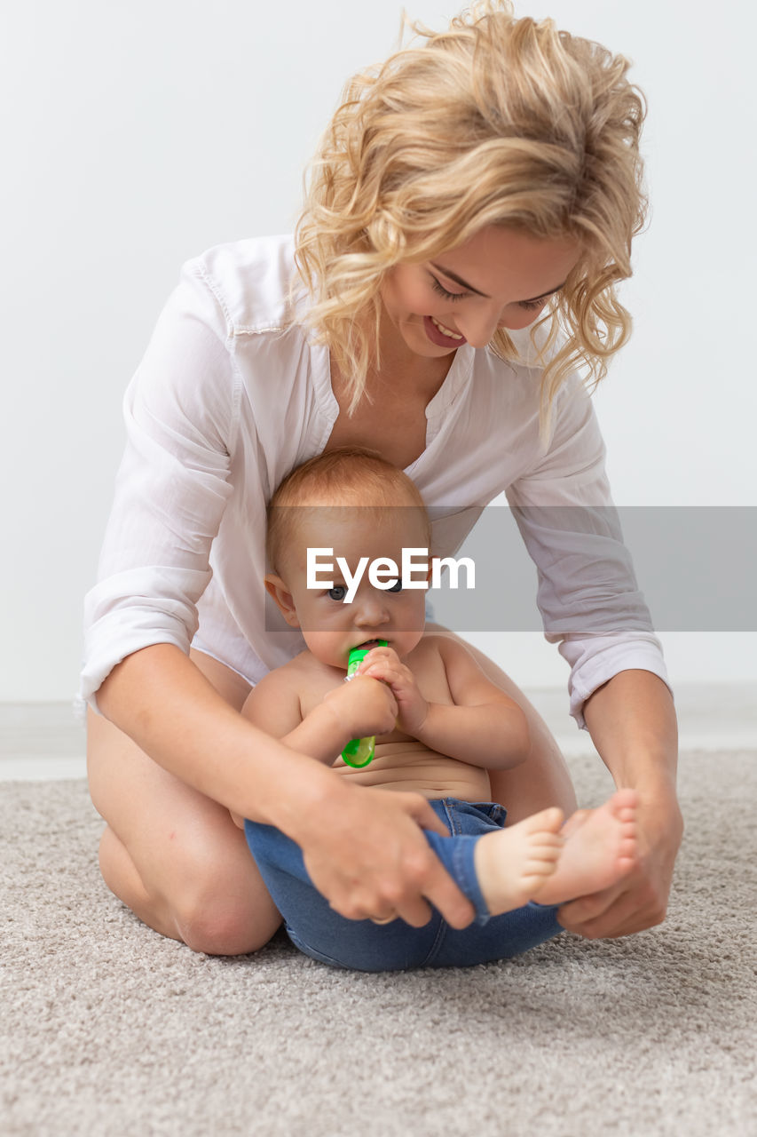 Mother playing with daughter at home