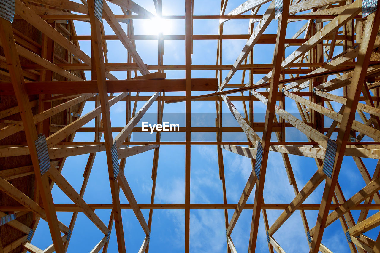 Low angle view of roof beam against sky