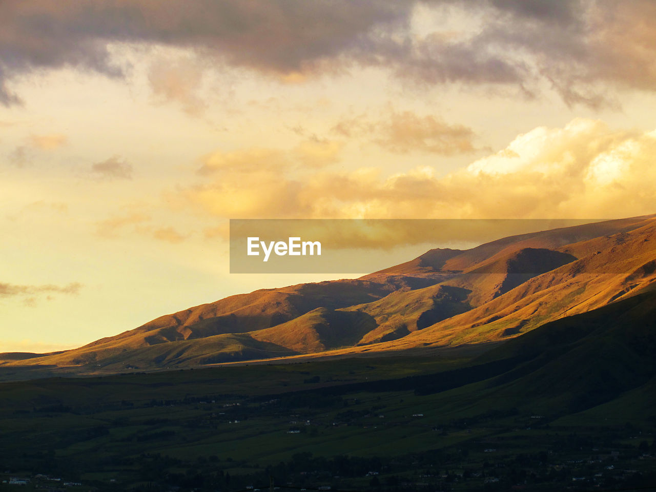 Scenic view of mountains against sky at sunset