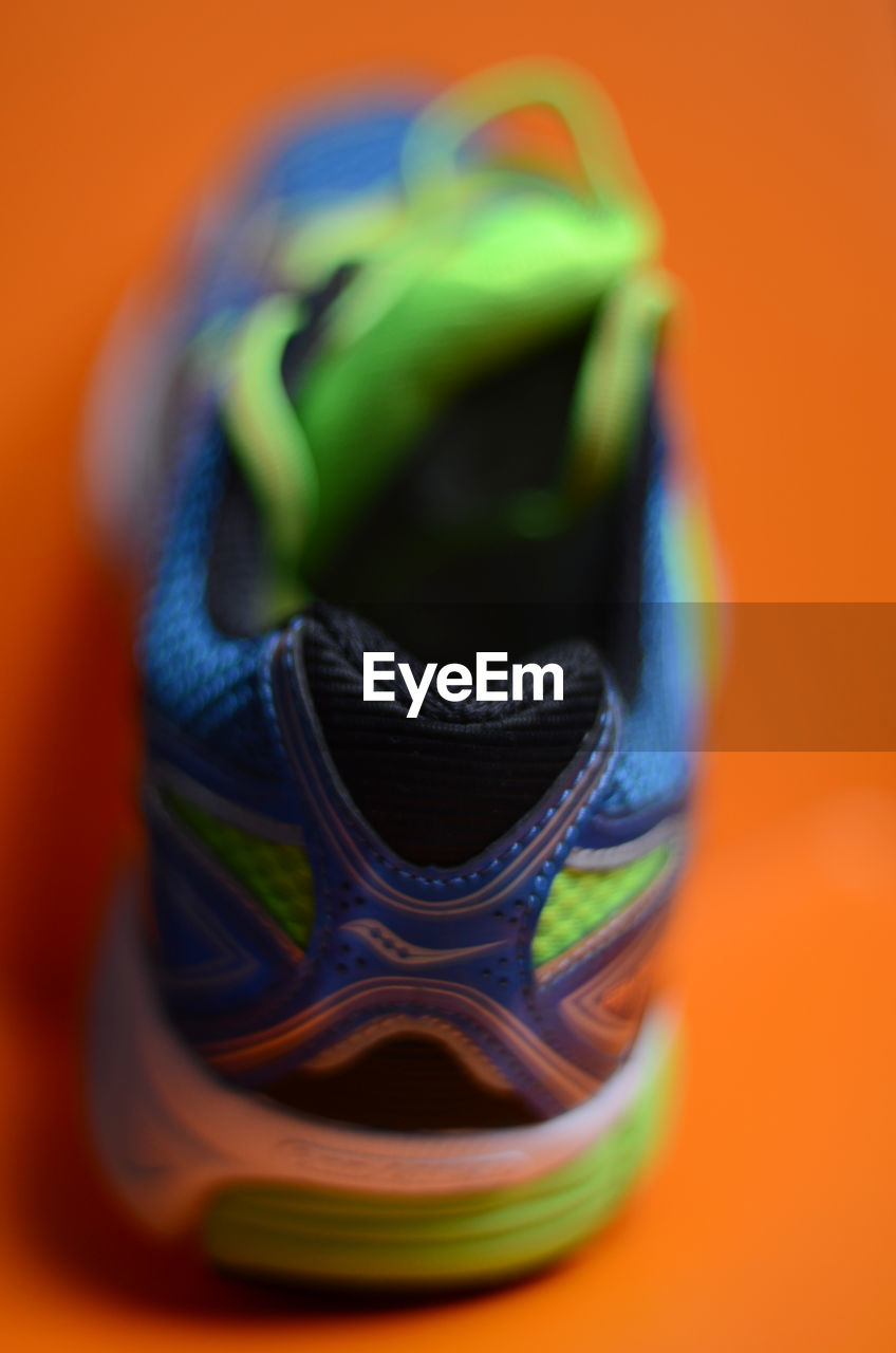 CLOSE-UP OF MULTI COLORED SHOES ON FLOOR