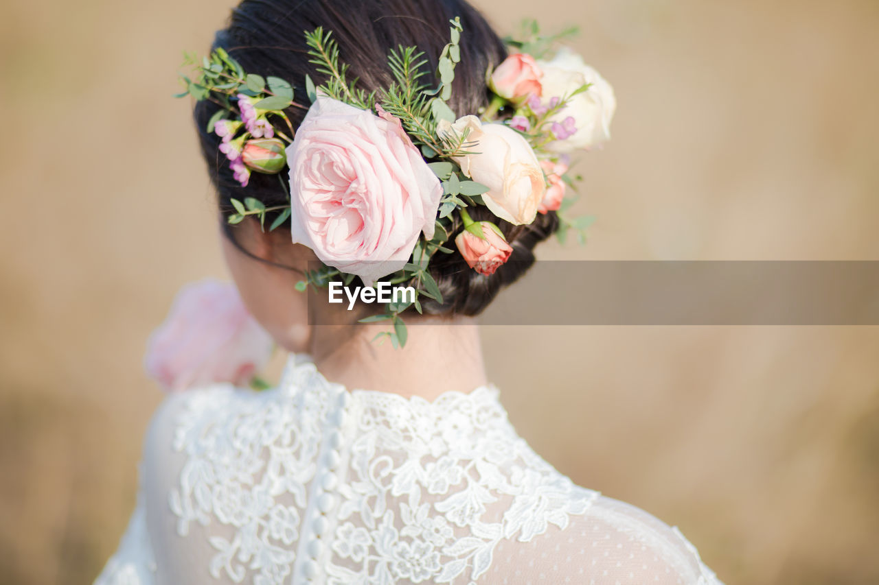 Rear view of bride wearing flowers