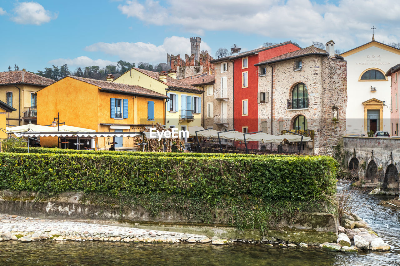 The beautiful colored houses of the hamlet of borghetto sul mincio reflecting on the water