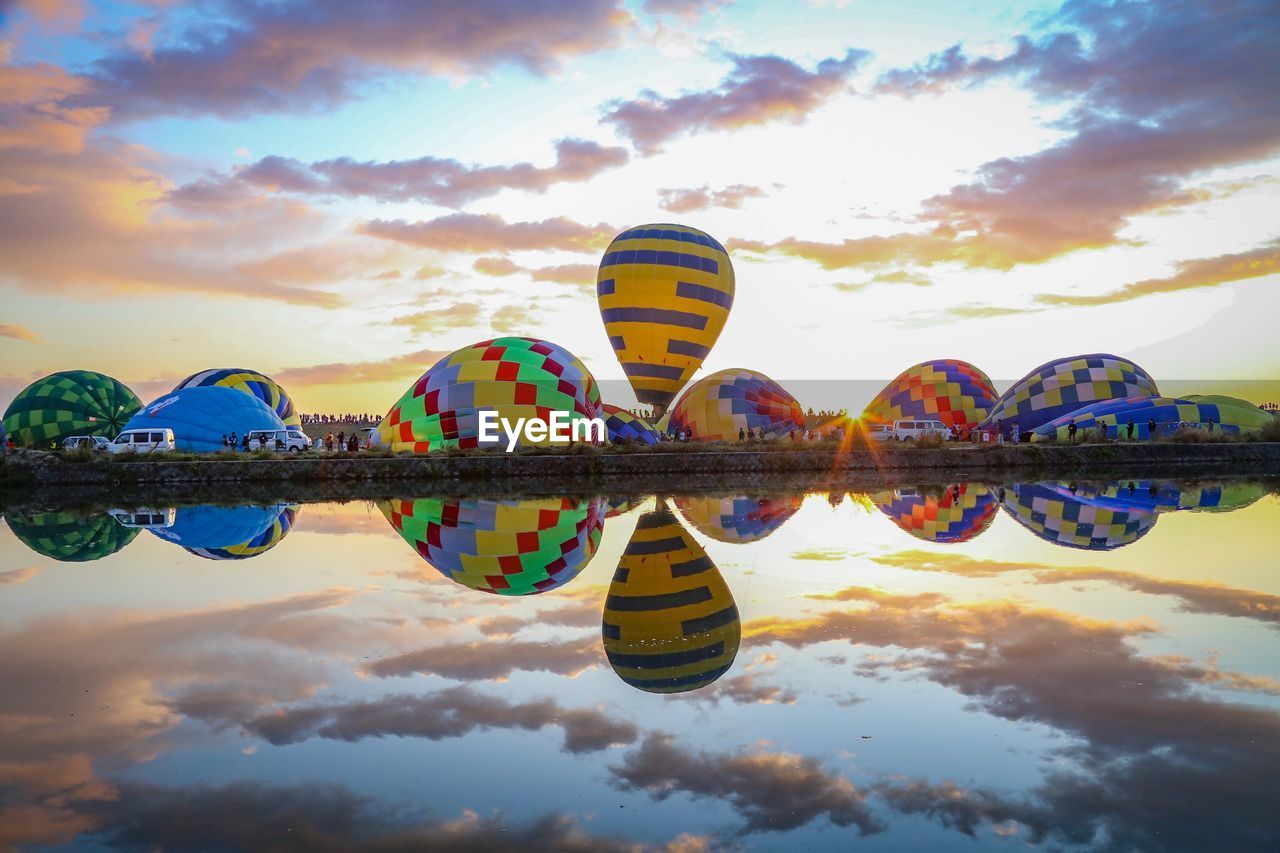 REFLECTION OF FERRIS WHEEL IN LAKE