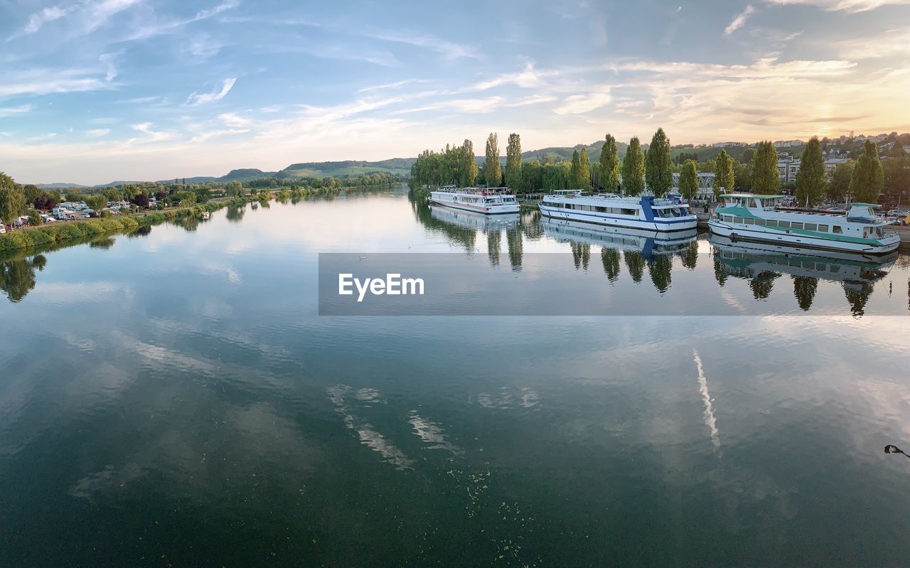 BOATS MOORED IN LAKE