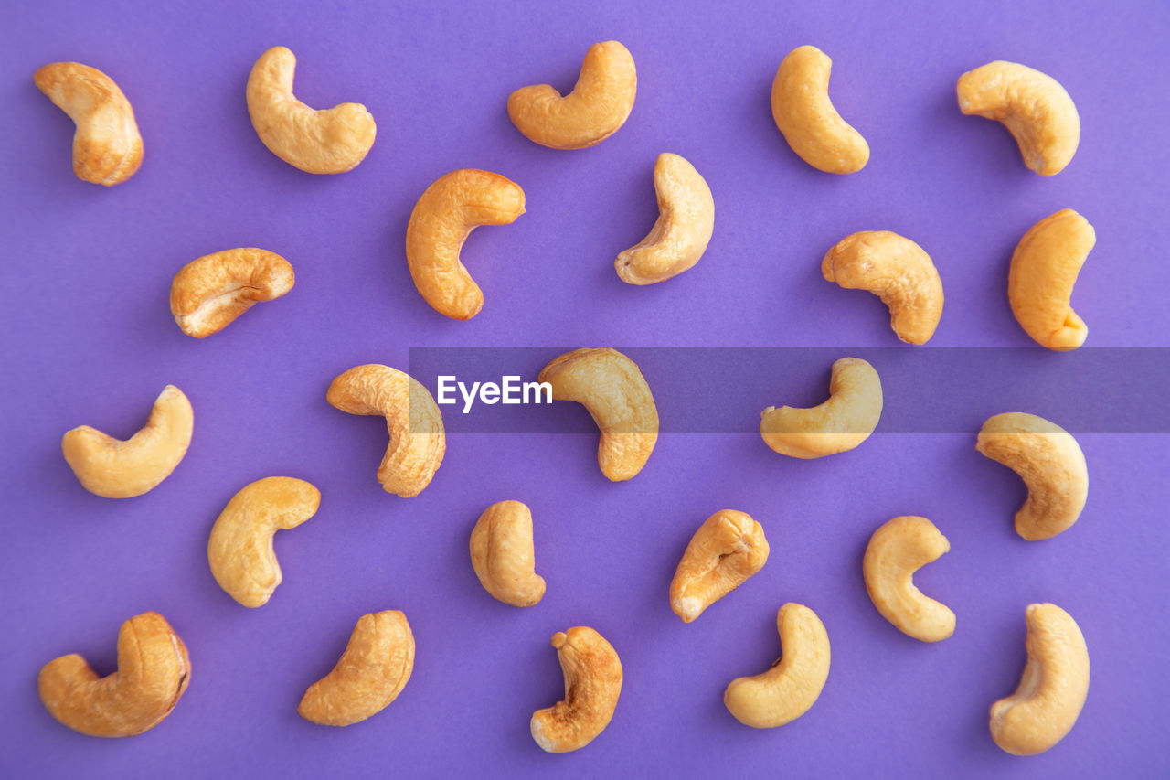 Close-up of cashews over purple background