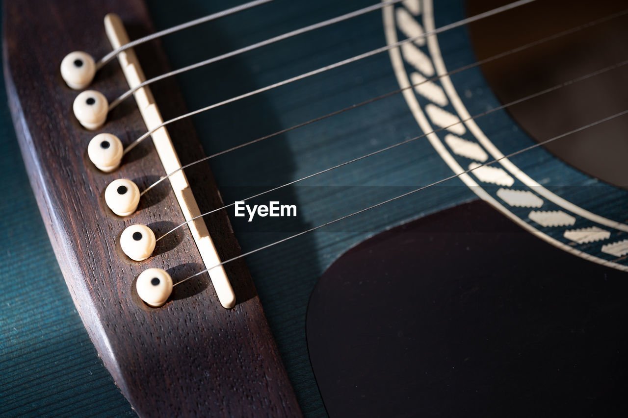 Close-up of guitar strings and bridge