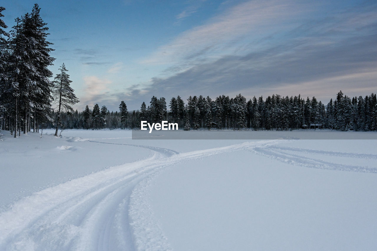 Snow covered field against sky