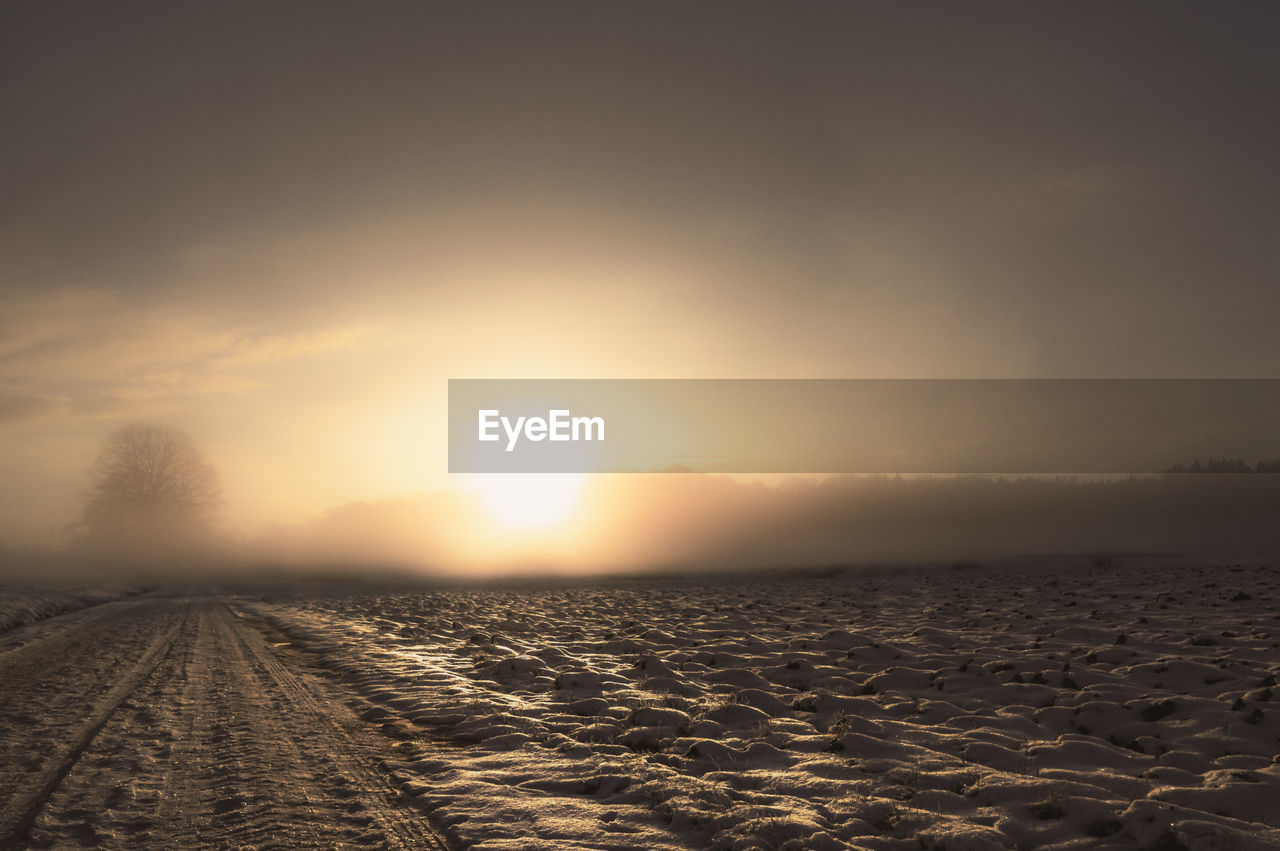 SCENIC VIEW OF LAND AGAINST SKY AT SUNSET