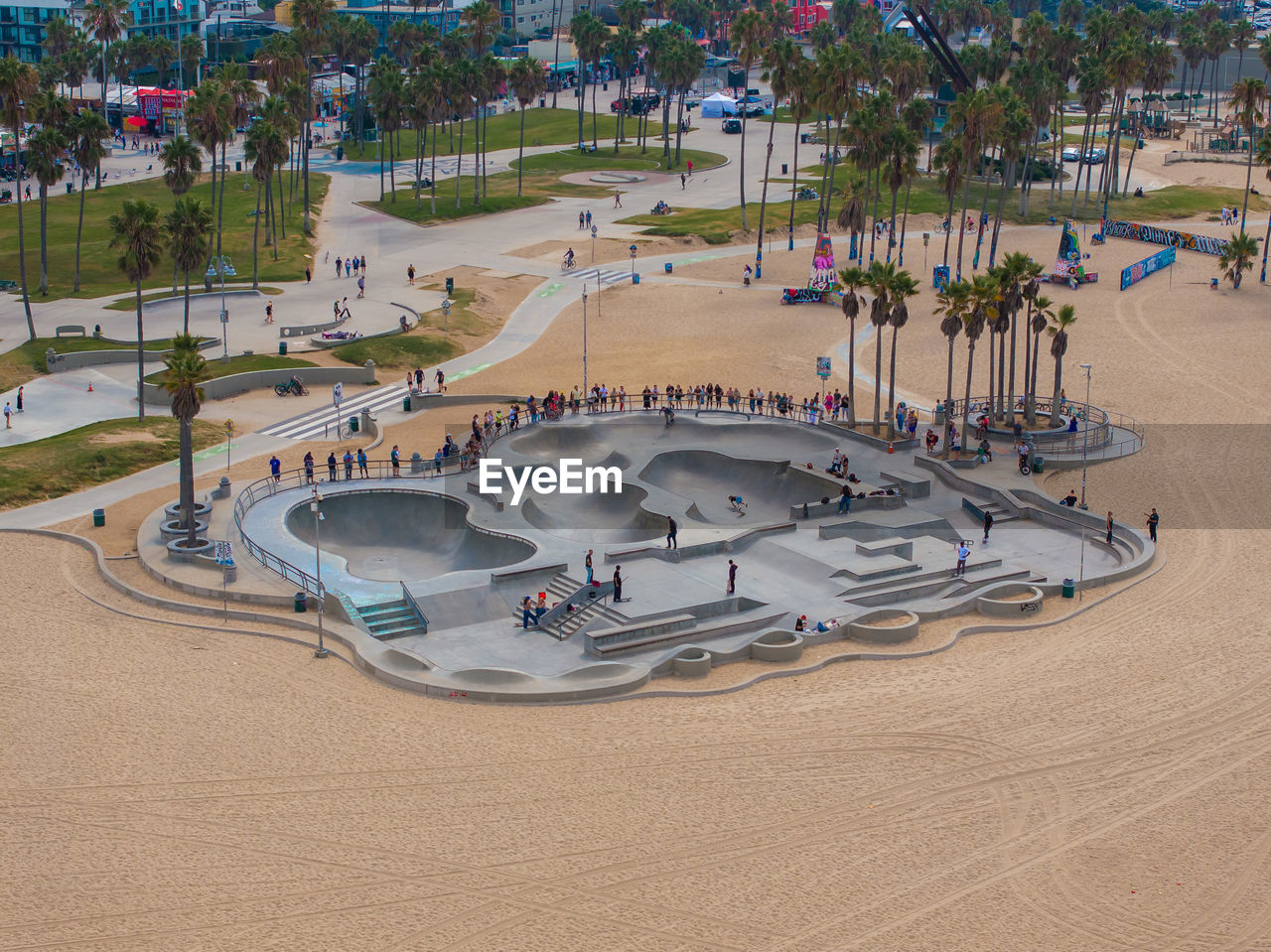 high angle view, playground, land, nature, sand, architecture, sports, tree, beach, plant, resort, water, day, outdoors, town square, group of people, travel destinations, crowd, park, built structure, travel, sport venue, water park, holiday, vacation, city, large group of people, transportation, leisure activity