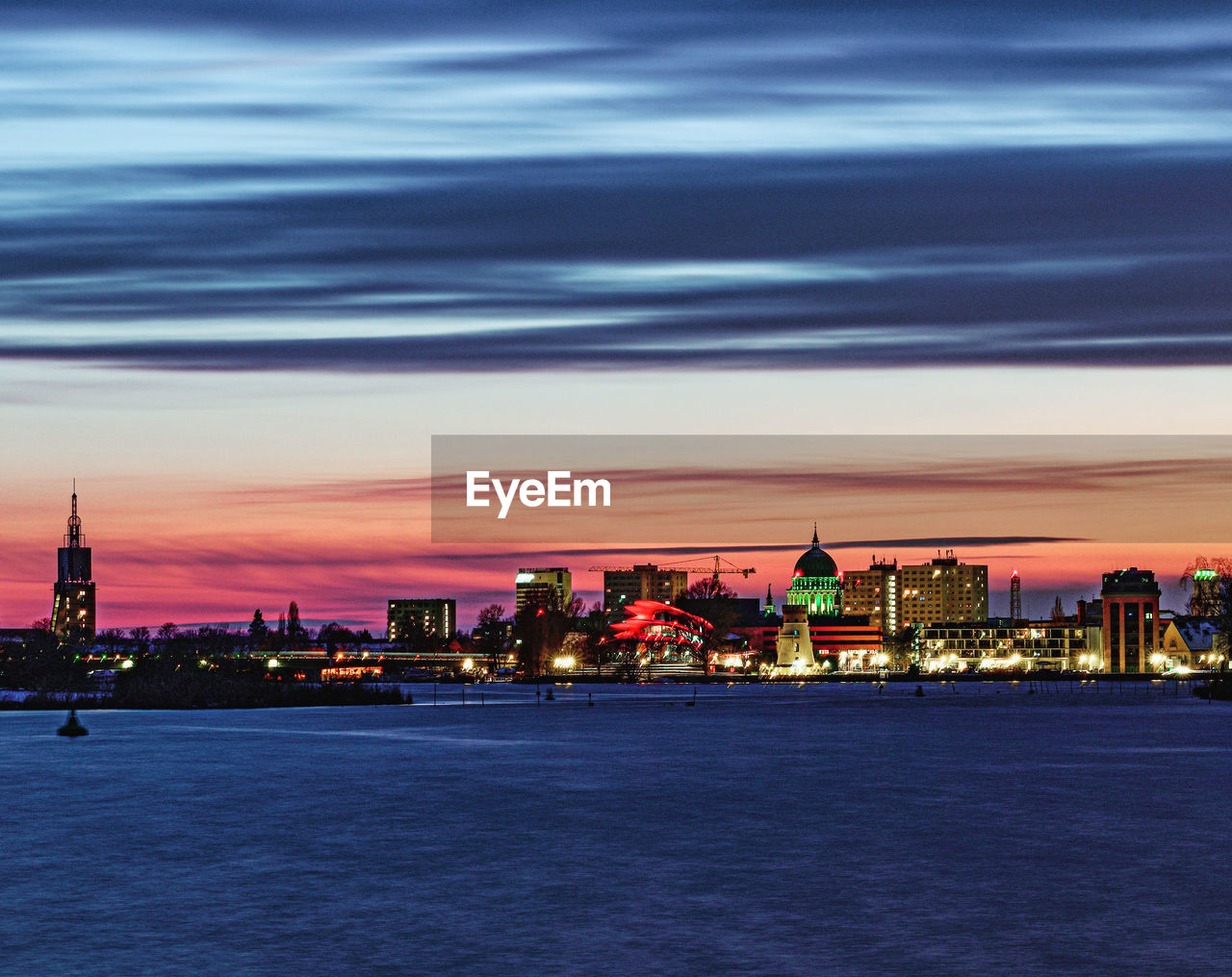 architecture, built structure, building exterior, city, horizon, skyline, sky, dusk, sunset, building, evening, cityscape, travel destinations, cloud, illuminated, nature, water, landscape, night, urban skyline, sea, no people, city life, outdoors, travel, reflection, tower, twilight, dramatic sky, beauty in nature, waterfront, tourism, office building exterior, skyscraper, afterglow, coast