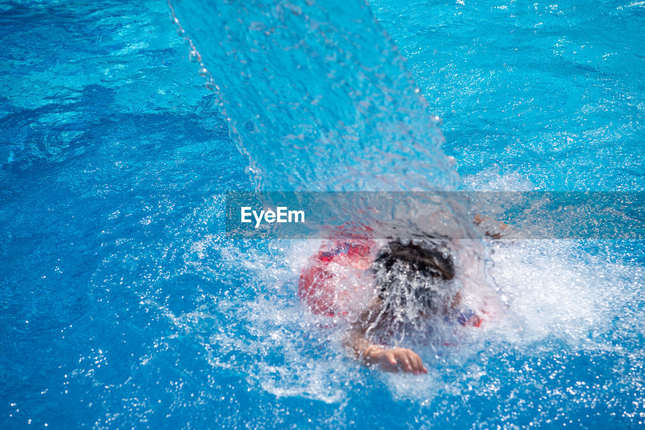 Close-up of boy swimming in pool