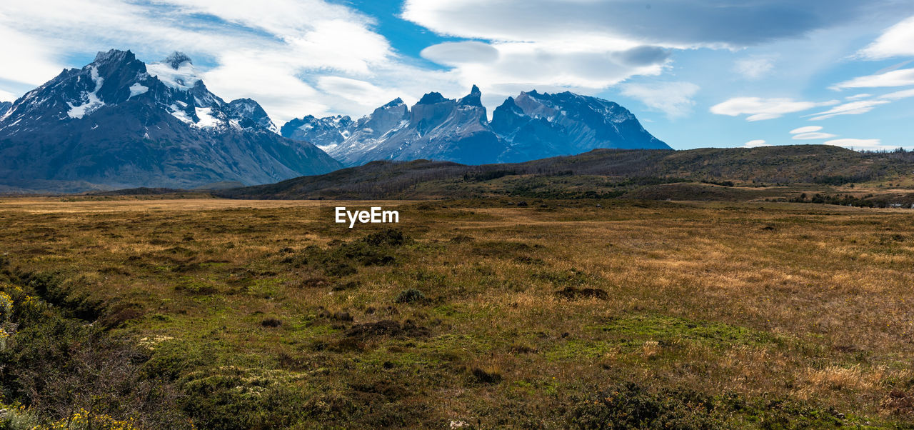 Scenic view of mountains against cloudy sky