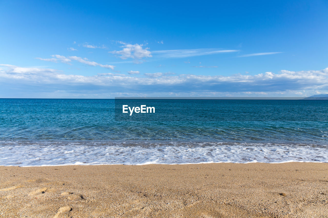 Scenic view of sea against blue sky