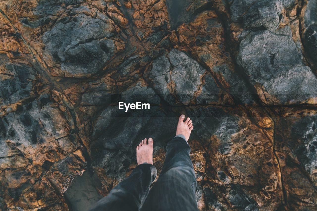 Low section of person standing on rocks