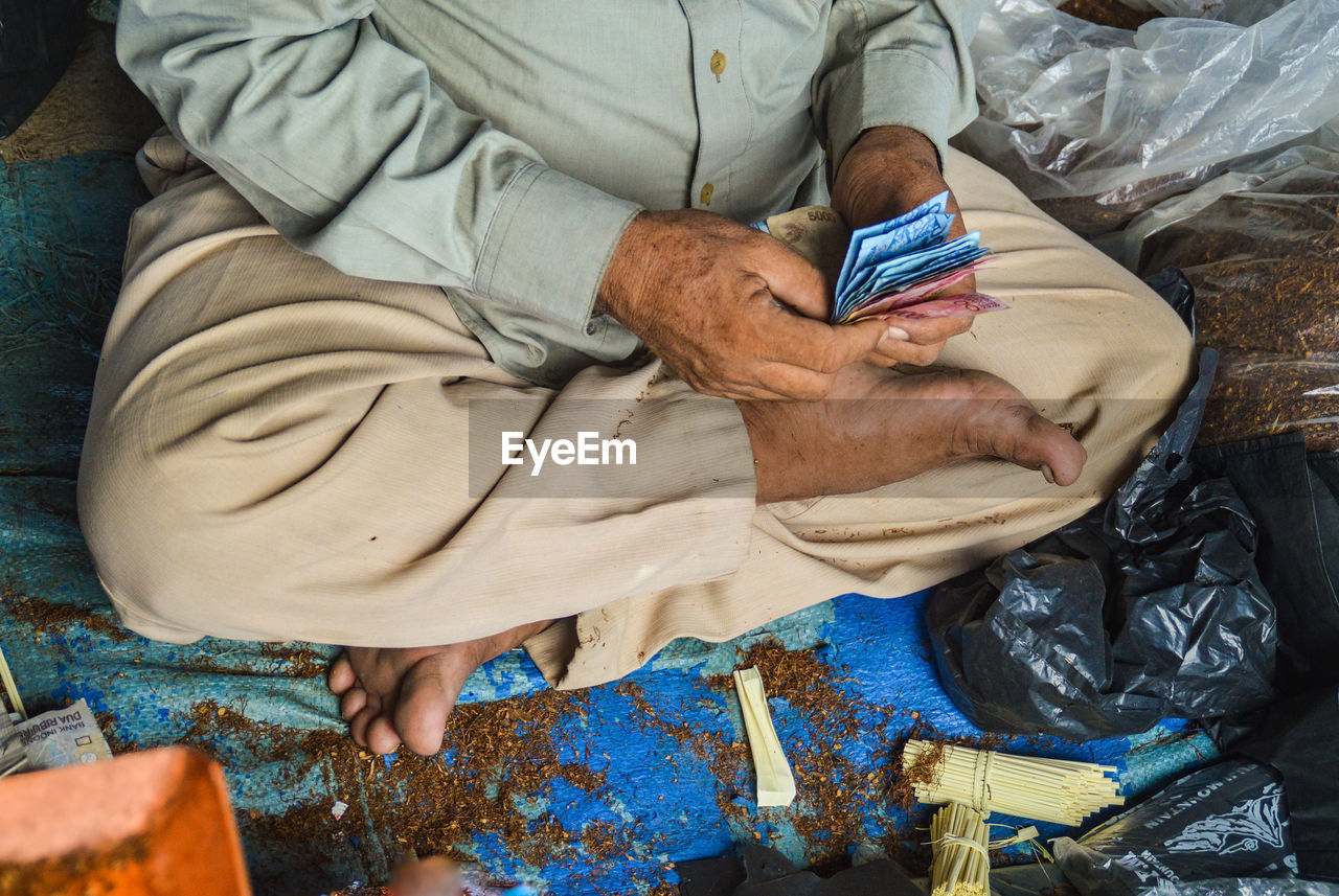 High angle view of man holding paper