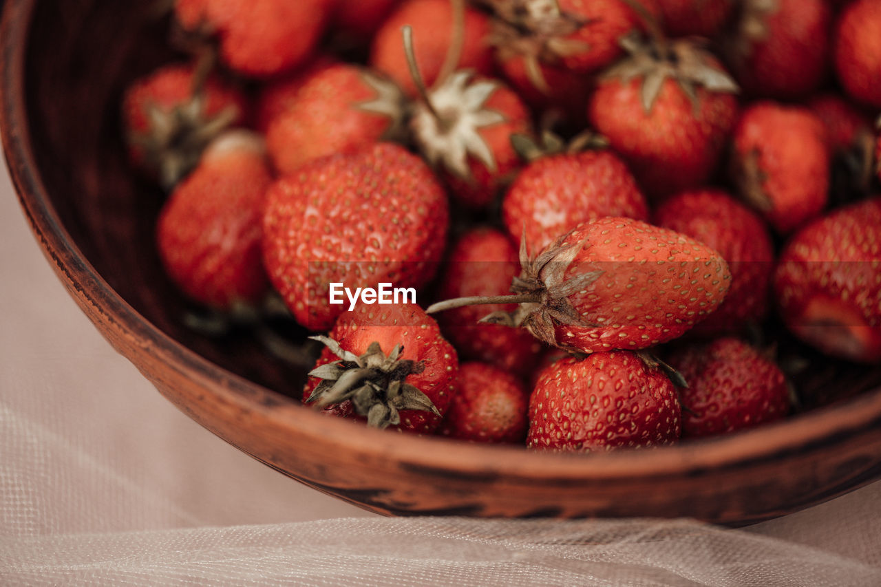 High angle view of strawberries in basket on table