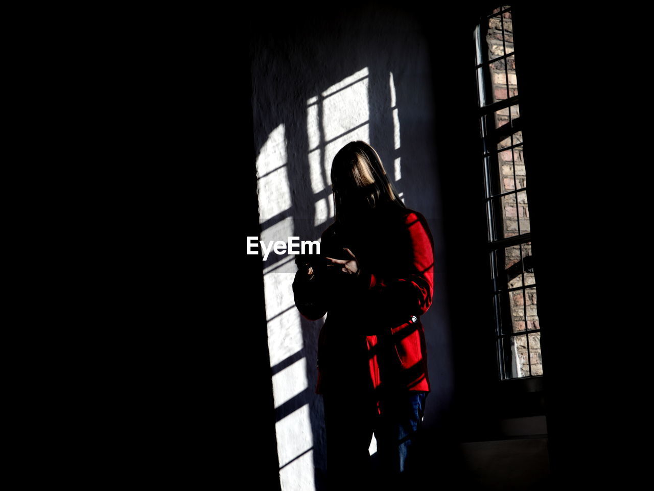 Woman standing by window