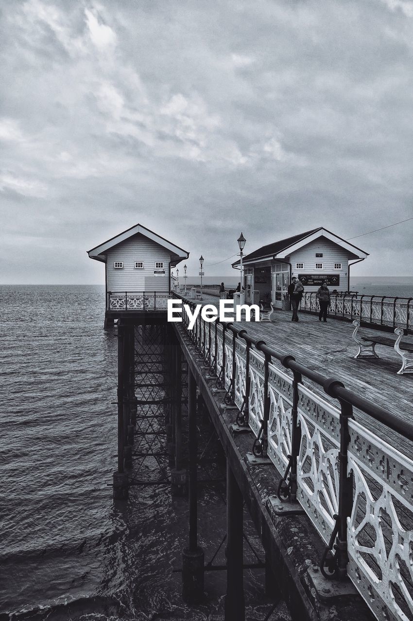 Penarth pier over sea against cloudy sky