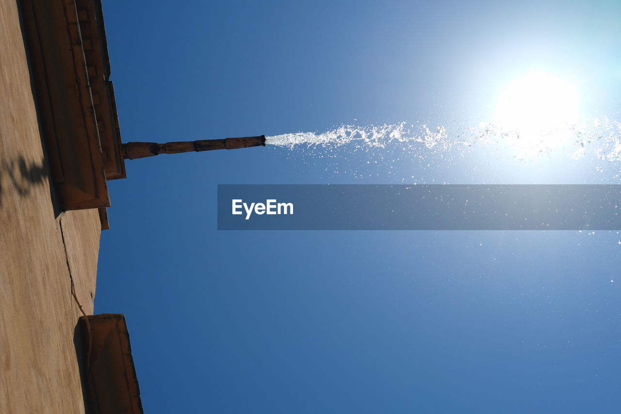 LOW ANGLE VIEW OF BUILT STRUCTURE AGAINST CLEAR BLUE SKY