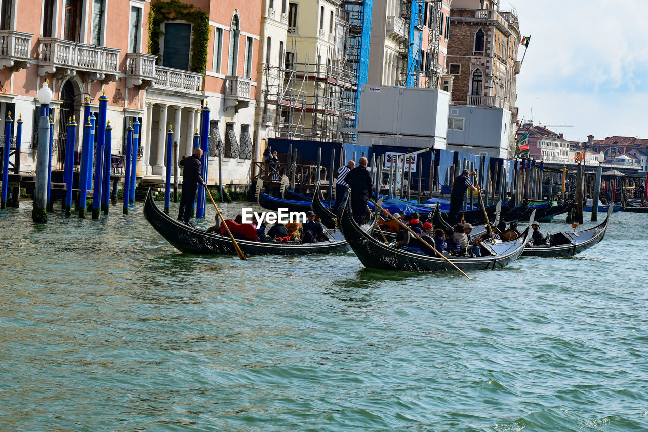 VIEW OF BOATS IN CANAL ALONG BUILDINGS