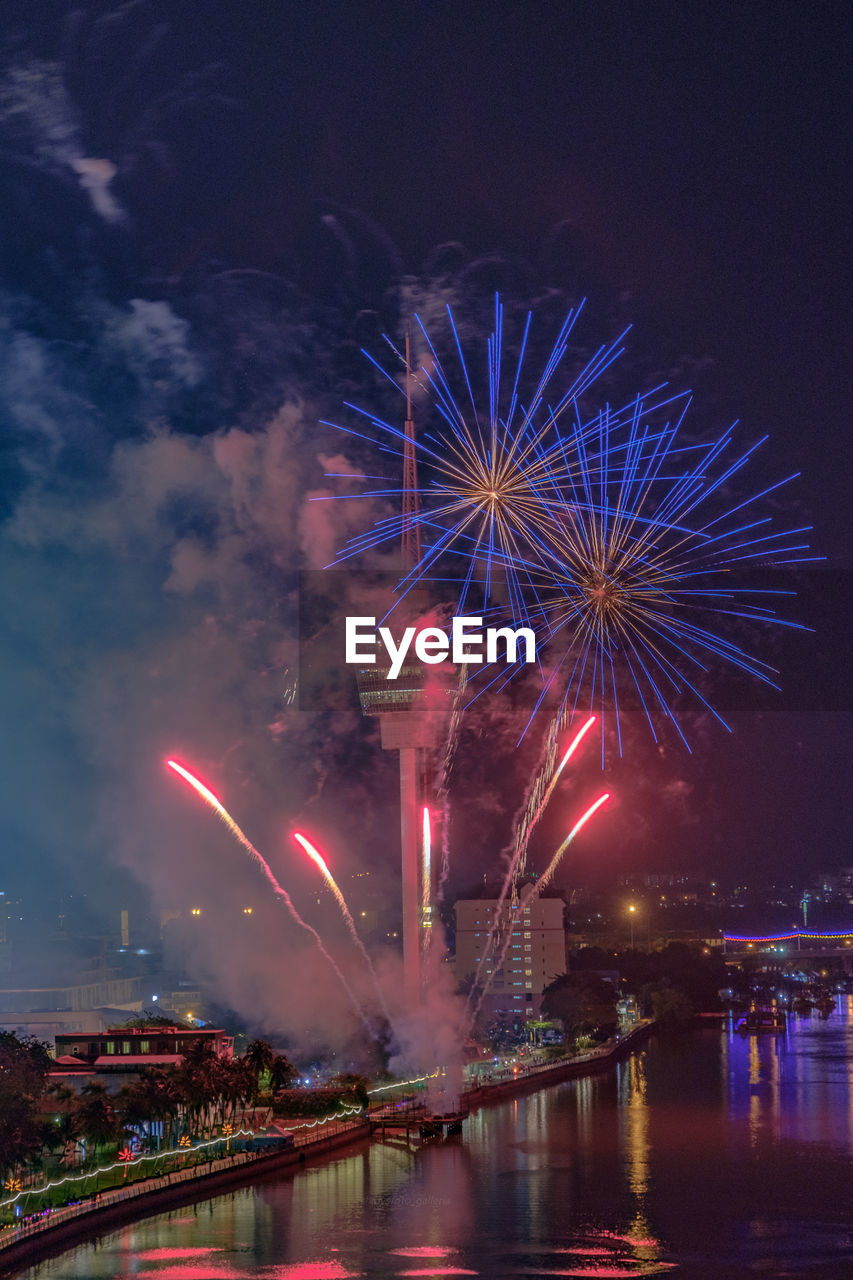 Low angle view of firework display at night