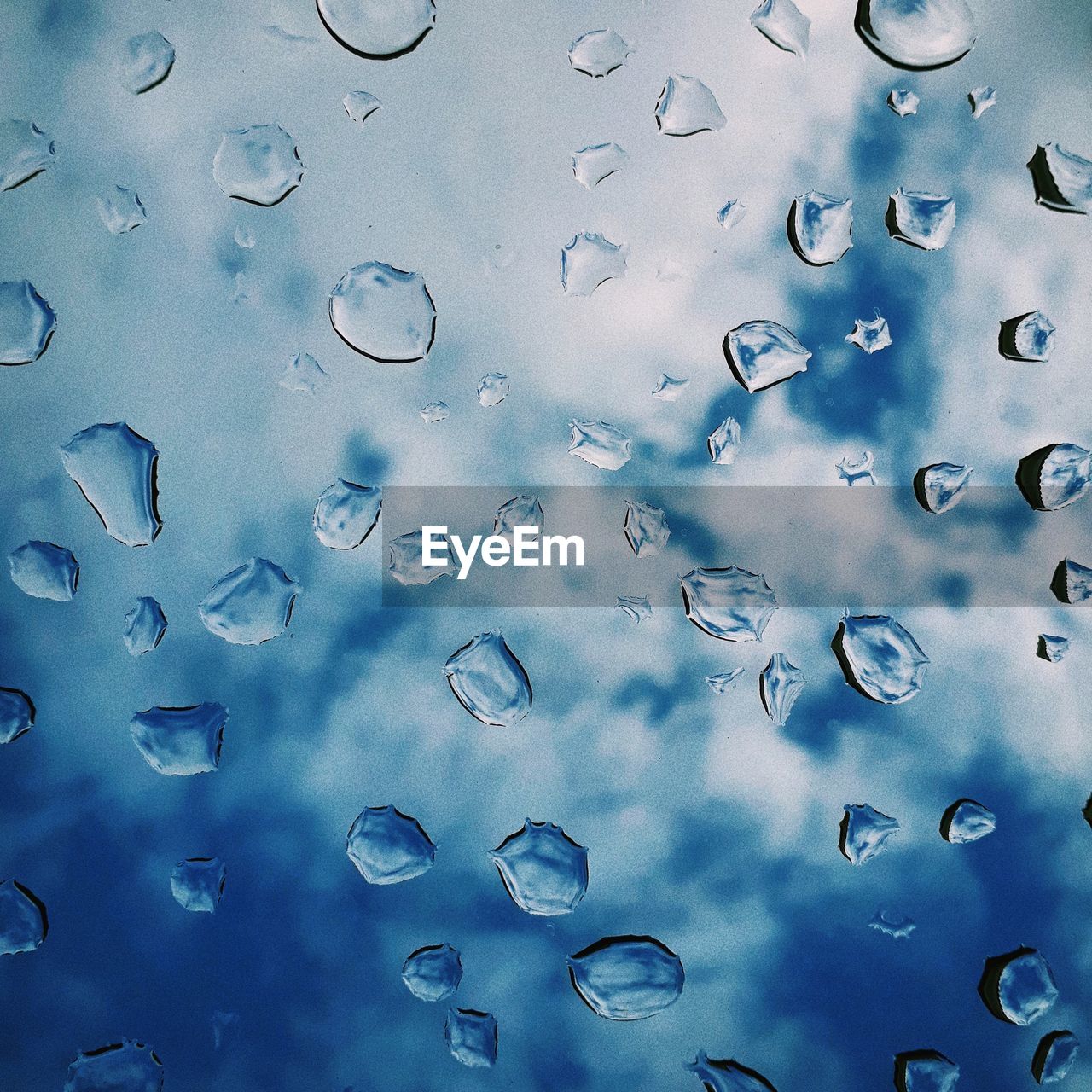 FULL FRAME SHOT OF RAINDROPS ON GLASS