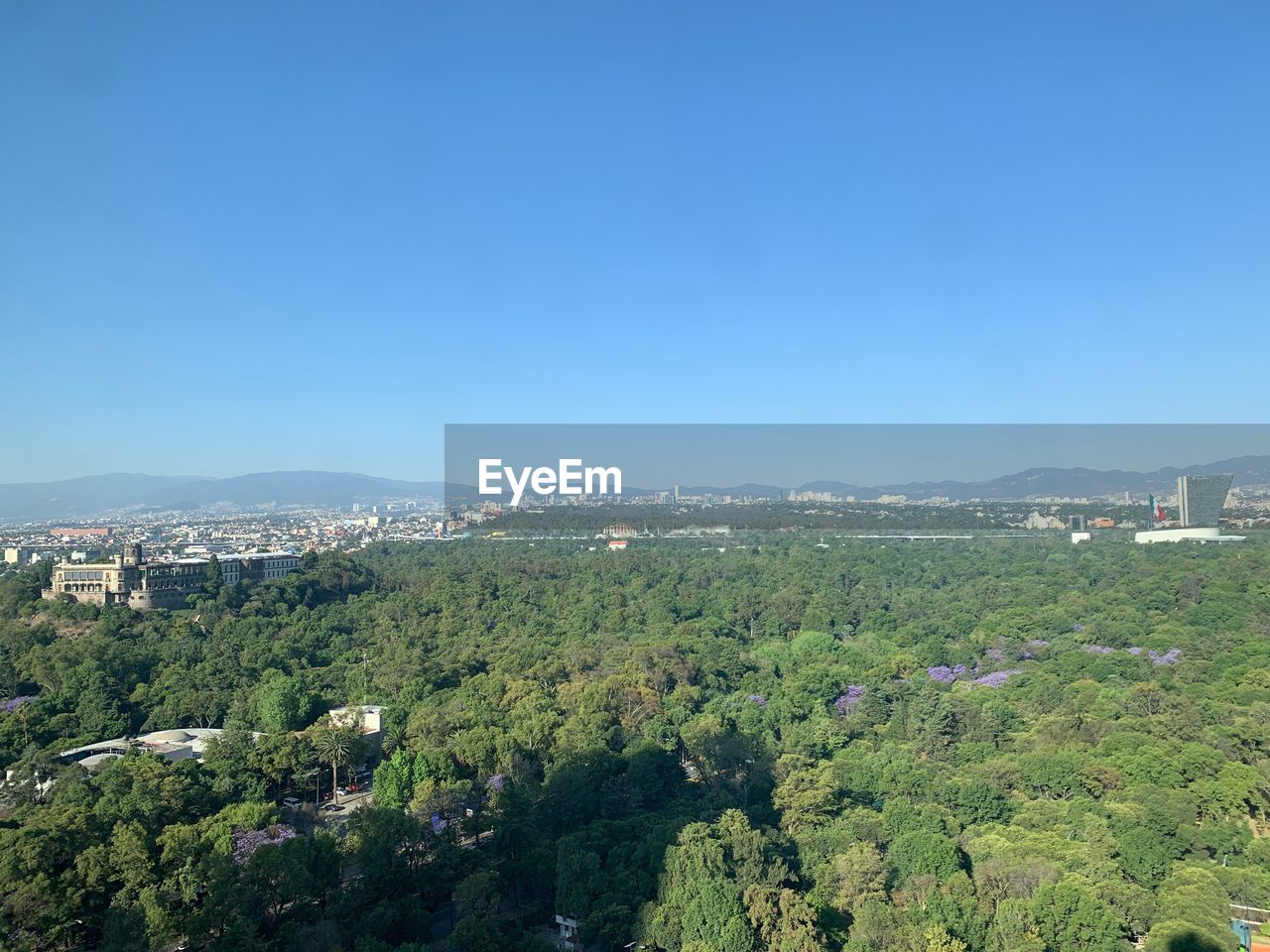 Aerial view of townscape against clear blue sky