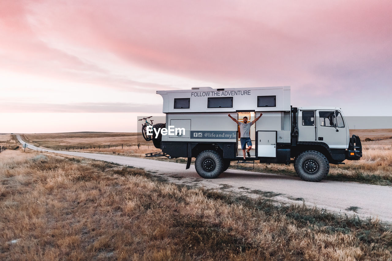 VIEW OF TRUCK ON ROAD AGAINST SKY