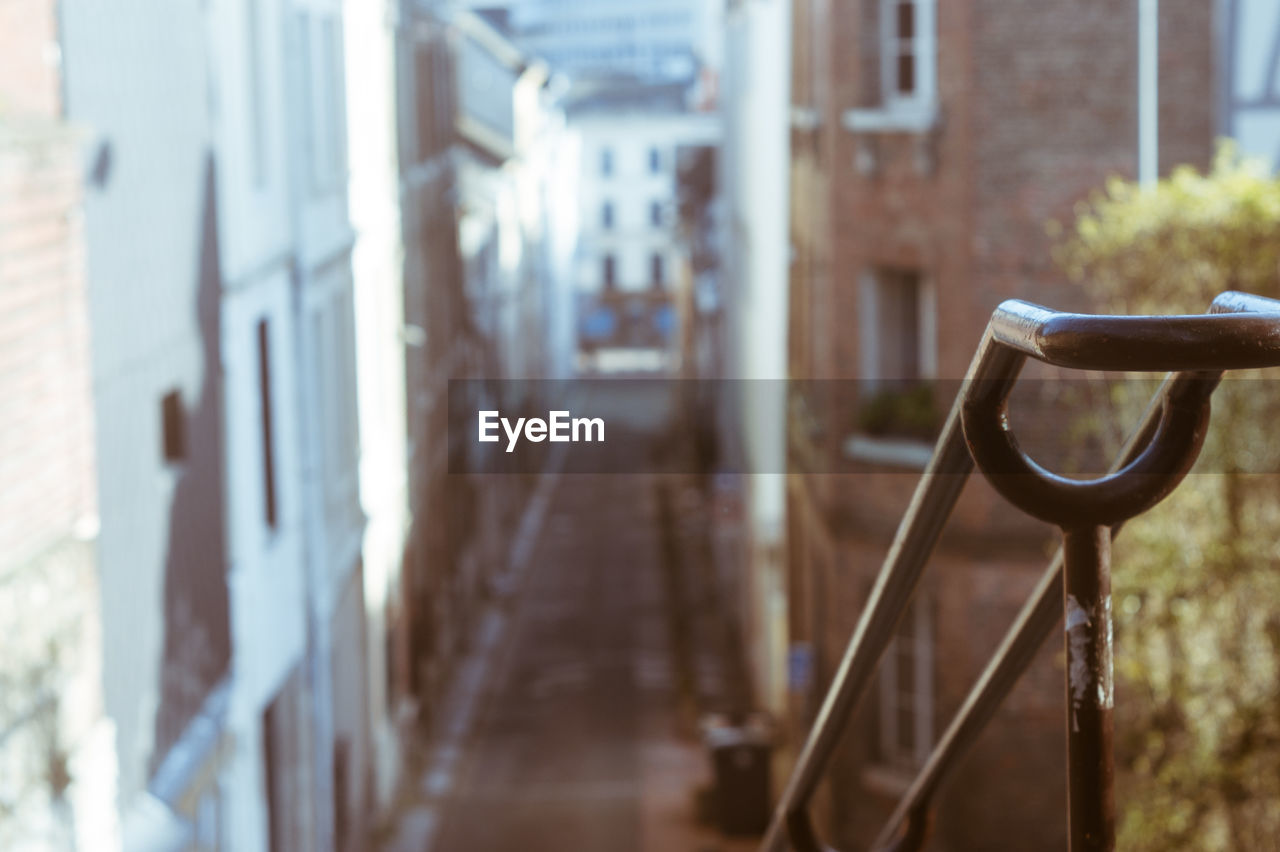 Metal railing on street against buildings