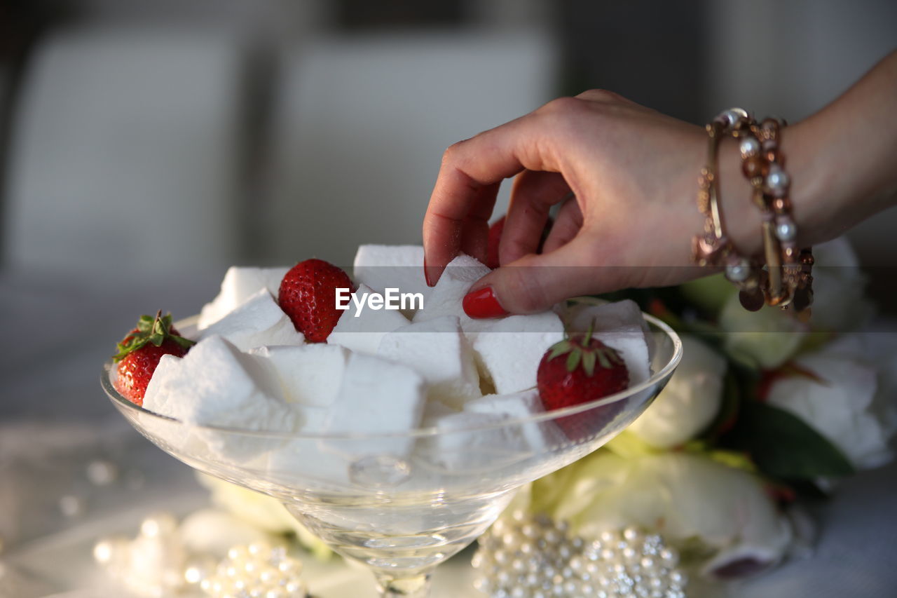 Close-up of hand holding sugar cubes