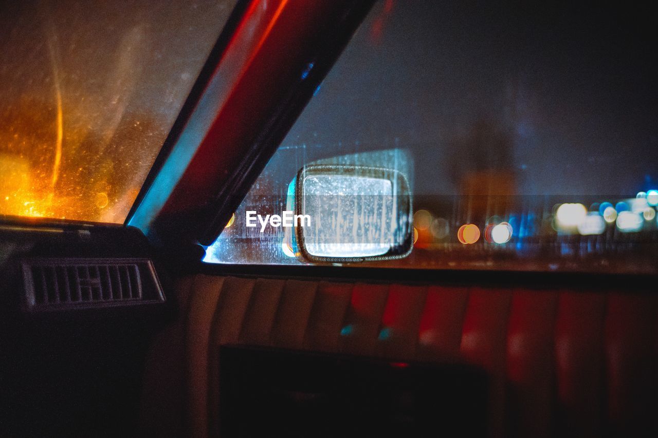 Car in illuminated city at night